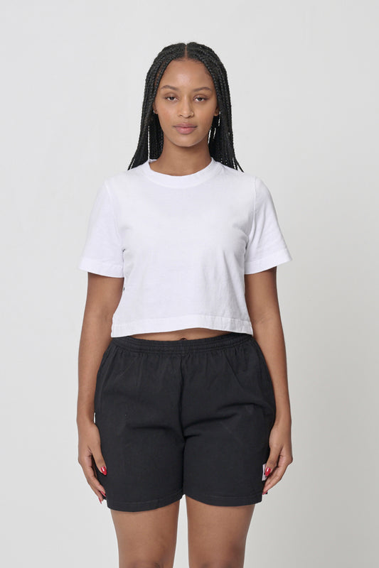 Baby Trash Tee in White - woman wearing a cropped t-shirt and bottom hem hitting just above her navel.