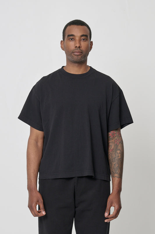 Front view of a 6-foot 2-inch tall man wearing Black Boxier Trash Tee in size L. Bottom hem cropped to the hip.