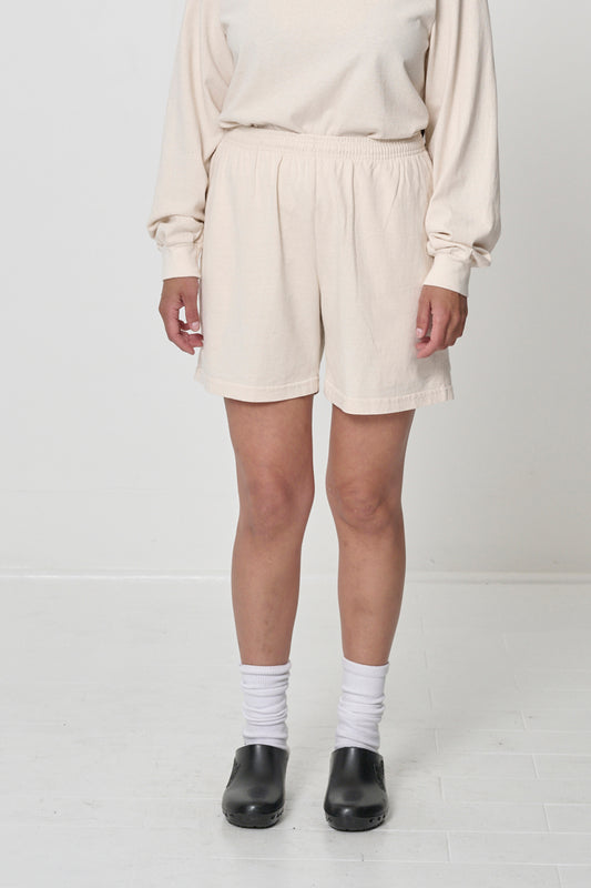 Scour Everyday Shorts on model, front. Relaxed fit, mid-thigh, and elastic waist.