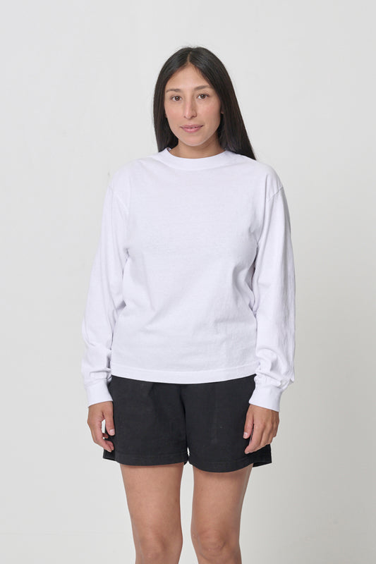5'4" woman in size S White Long Sleeve Boxier Trash Tee; shirt hem at lower-mid-hip, arms at sides.