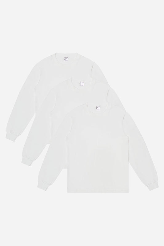 Flat lay of 3 slightly offset White Long Sleeve Trash Tees.