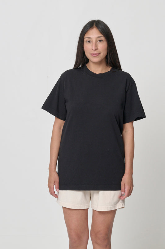 Front view of a woman wearing the Short Sleeve Trash Tee in Black, showcasing its relaxed fit.