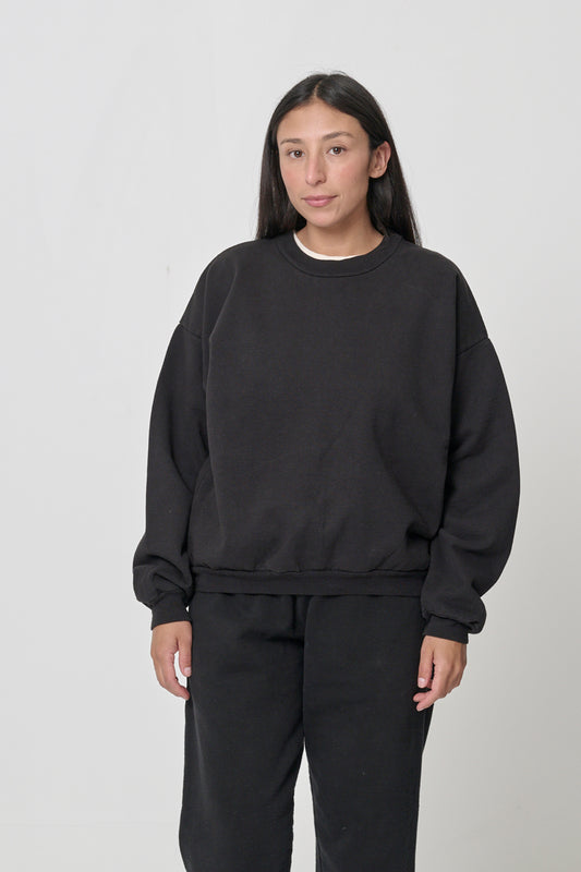 Front view: 5'4" woman wearing Black Trash Crewneck in size S. Hem hits her upper middle hip.
