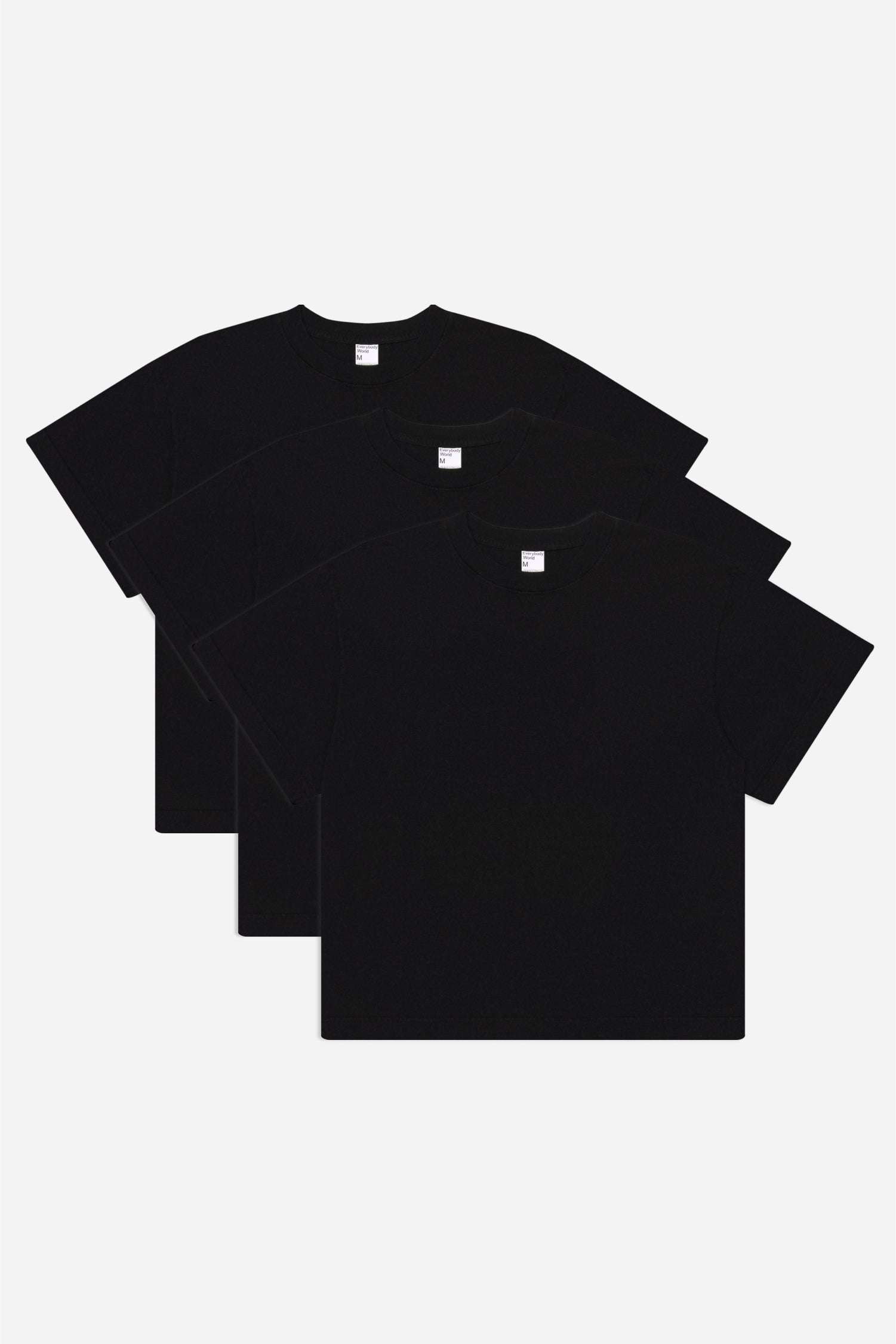 Flat lay of 3 slightly offset Black Boxier Trash Tees.
