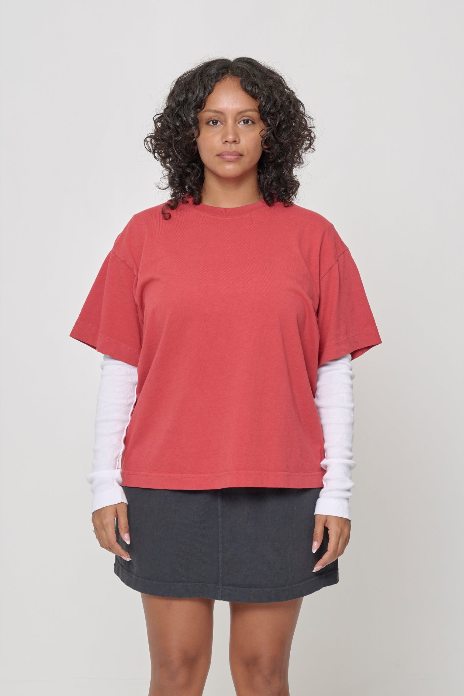 5'7" woman in a size M Cedar Boxier Trash Tee. Hem at her lower middle hip.