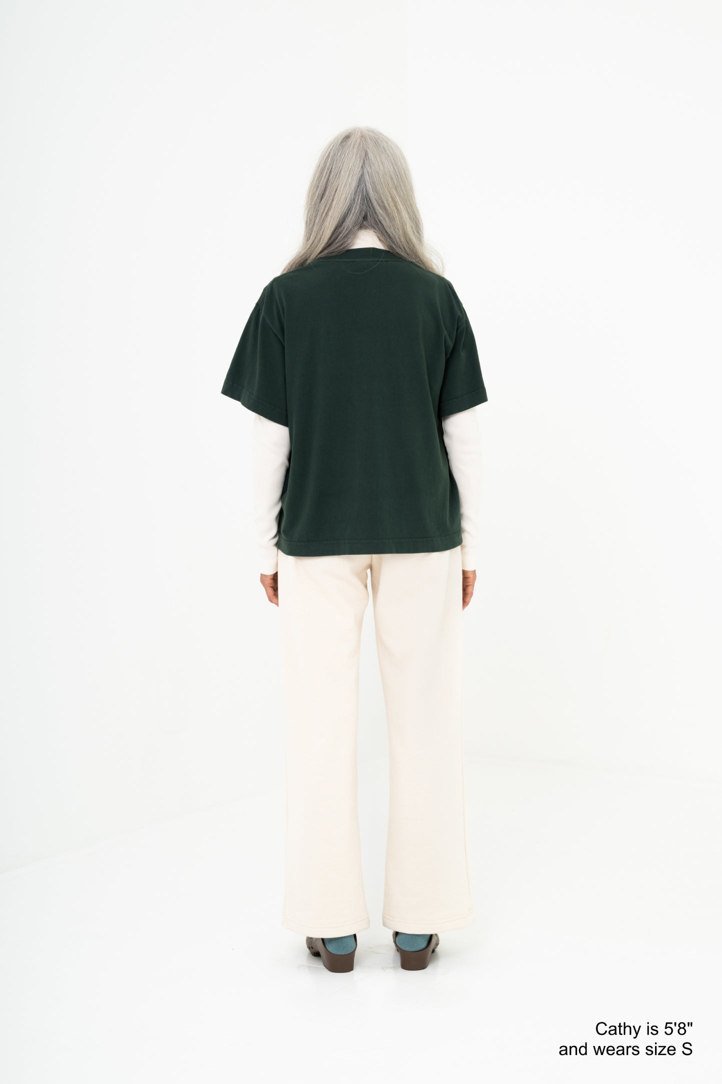 Model wearing a green shirt with scour pants
