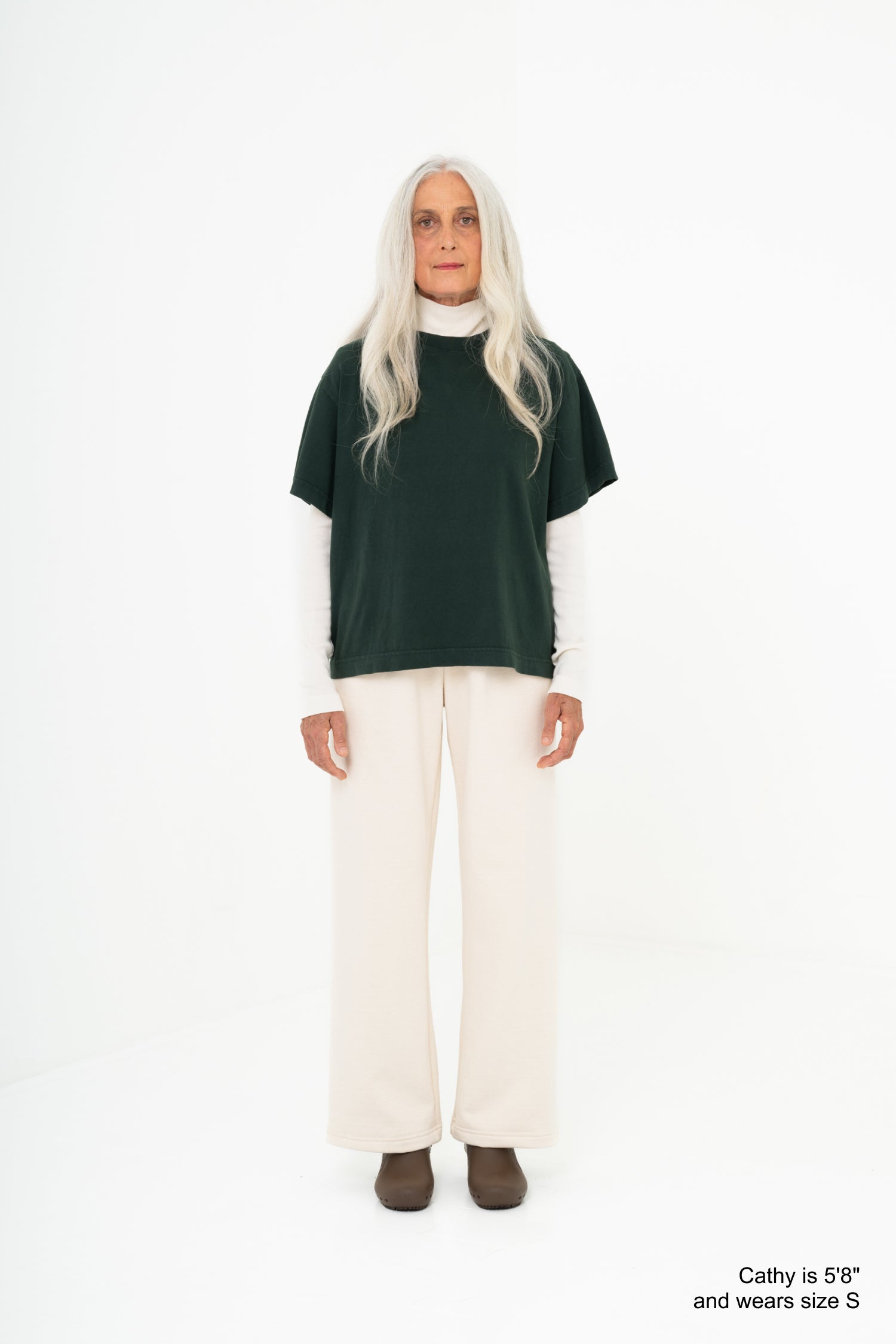 Model wearing a green shirt and scour pants