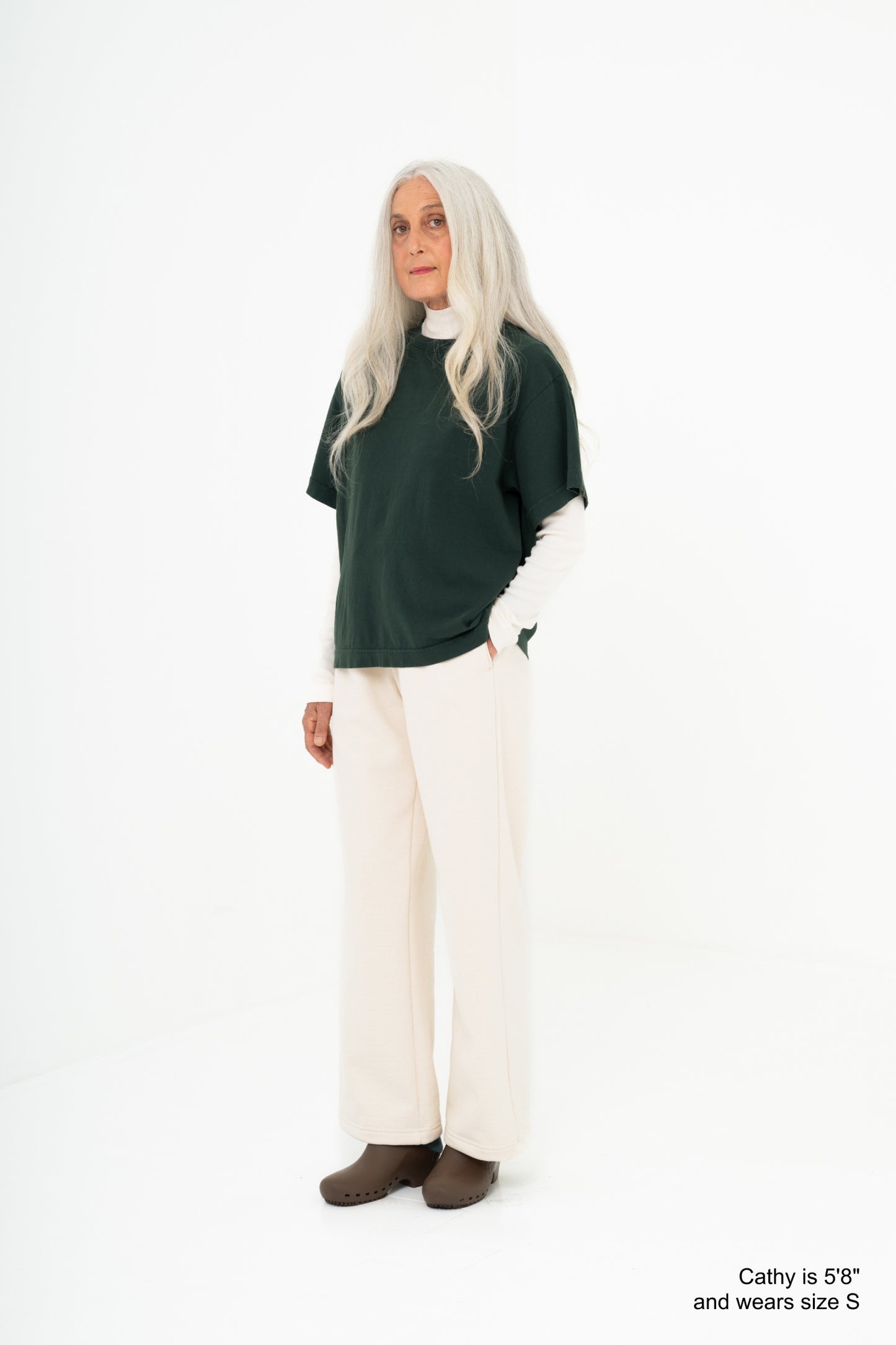 Model wearing a green shirt with scour pants