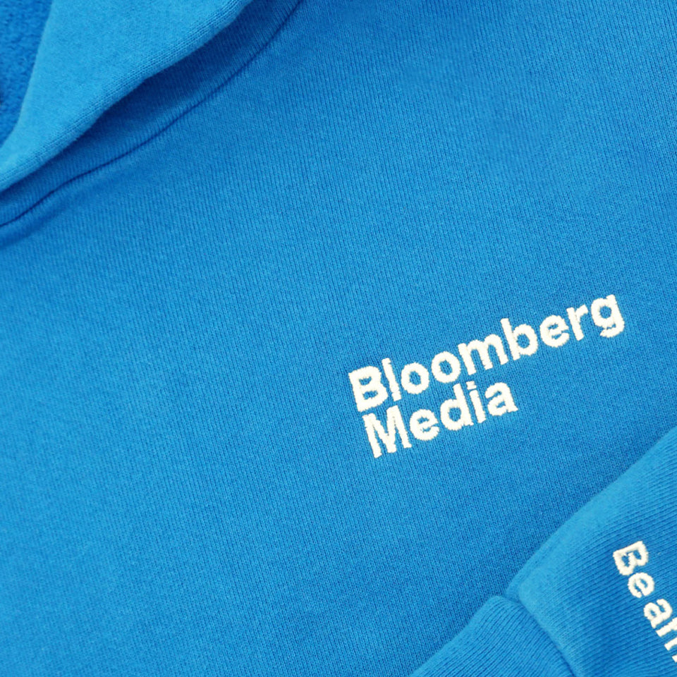 Close up of custom gblue Trash Hoodie pocket with Bloomberg Media logo embroidered.