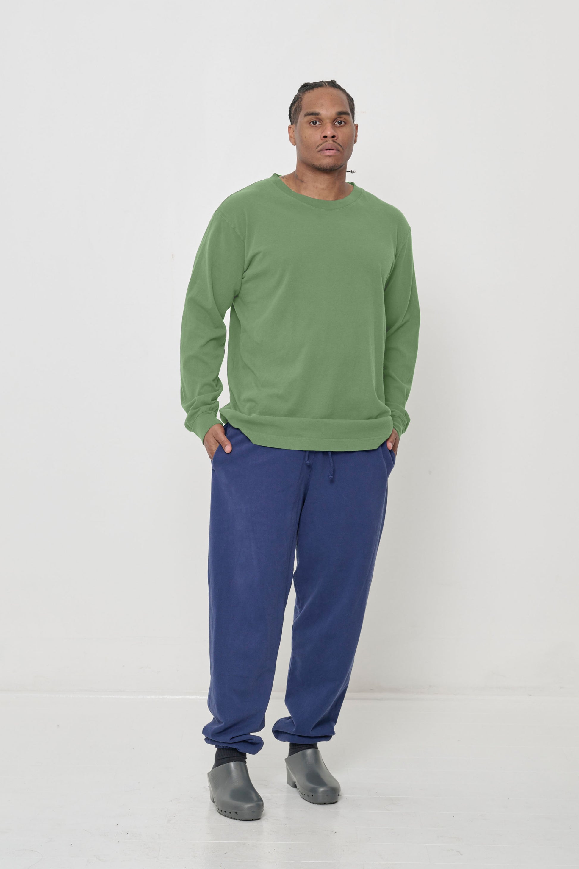 A 6' man in a size L Fox Green Long Sleeve Trash Tee. Styled with Blue Trash Sweatpants.