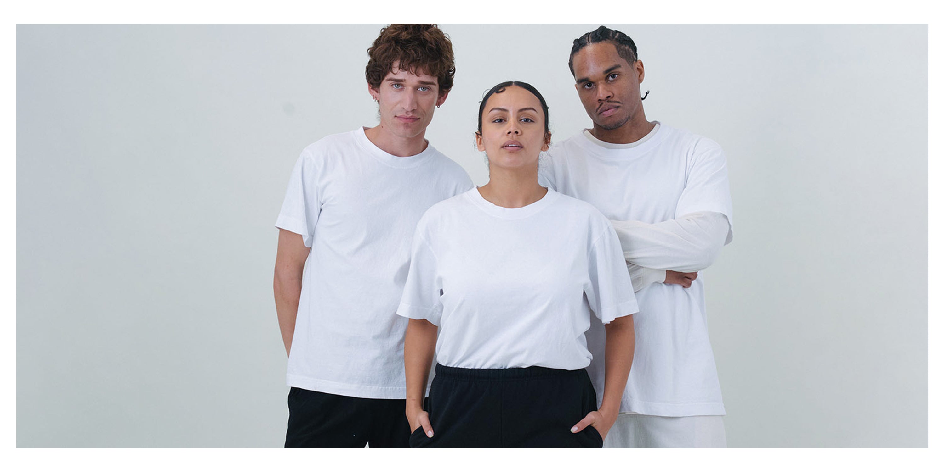 Three people wearing Short Sleeve Trash Tees in White against a plain background