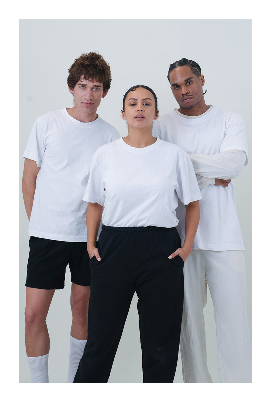 Three people wearing Short Sleeve Trash Tees in White against a plain background