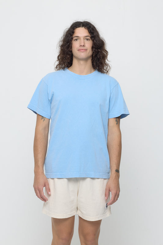 A model in the Short Sleeve Trash Tee in Cielo. Hem ends at lower hip.
