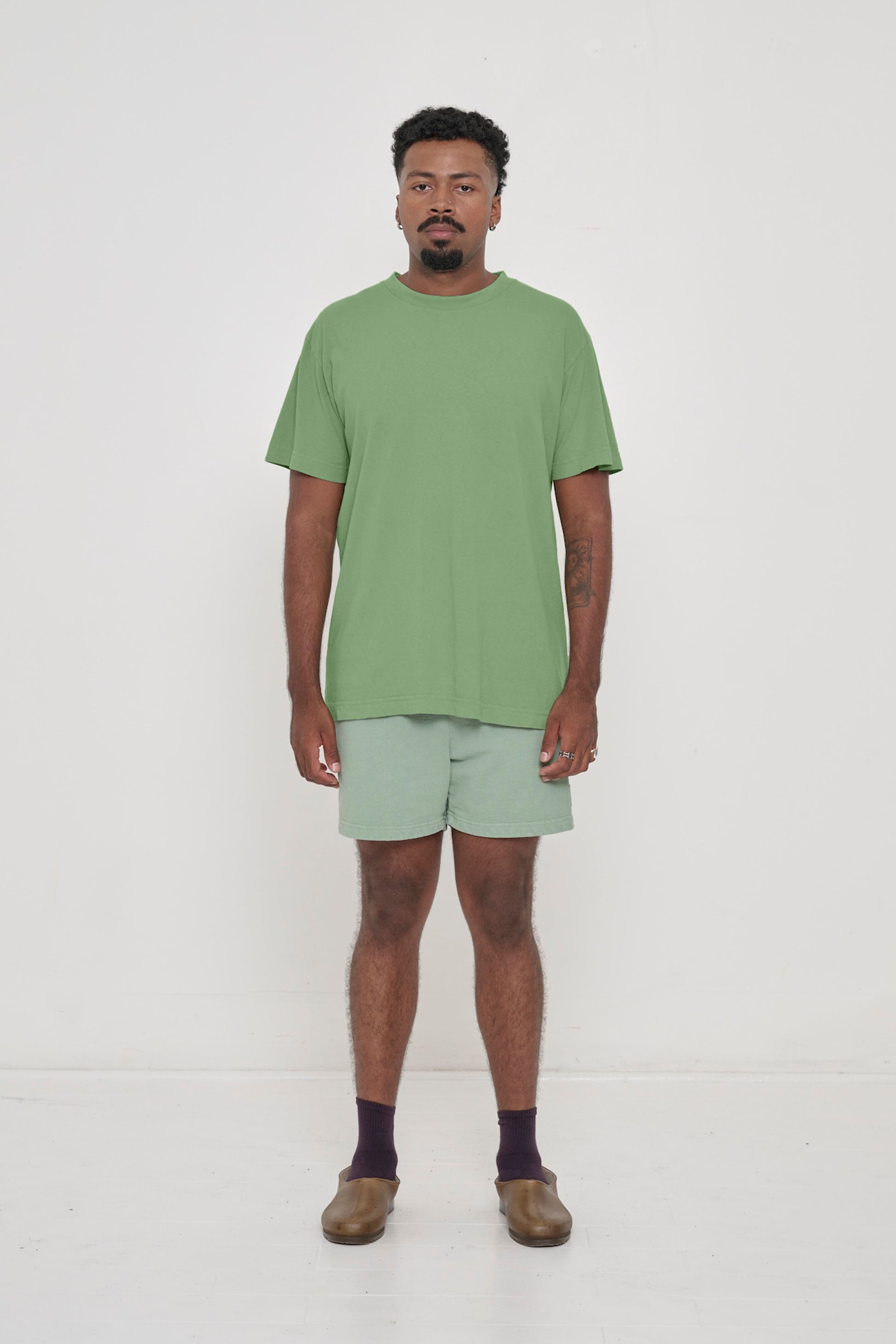 A man in a Fox Short Sleeve Trash Tee. Hem ends just below the hip.