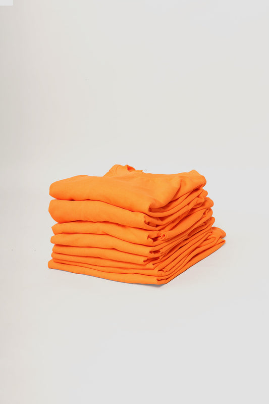 Stack of Orange Short Sleeve Trash Tees