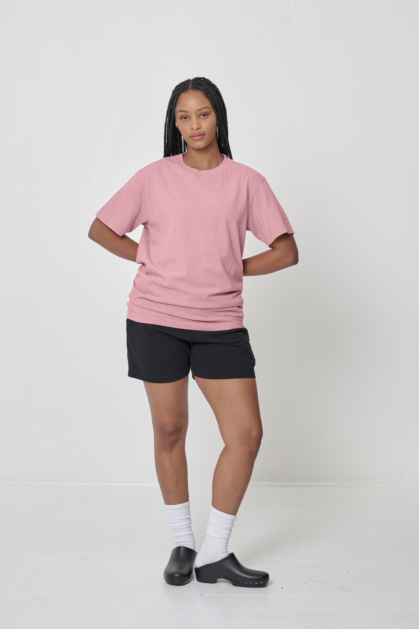 5'10" woman in a size M. Shirt slightly scrunched up to end at her mid hip.