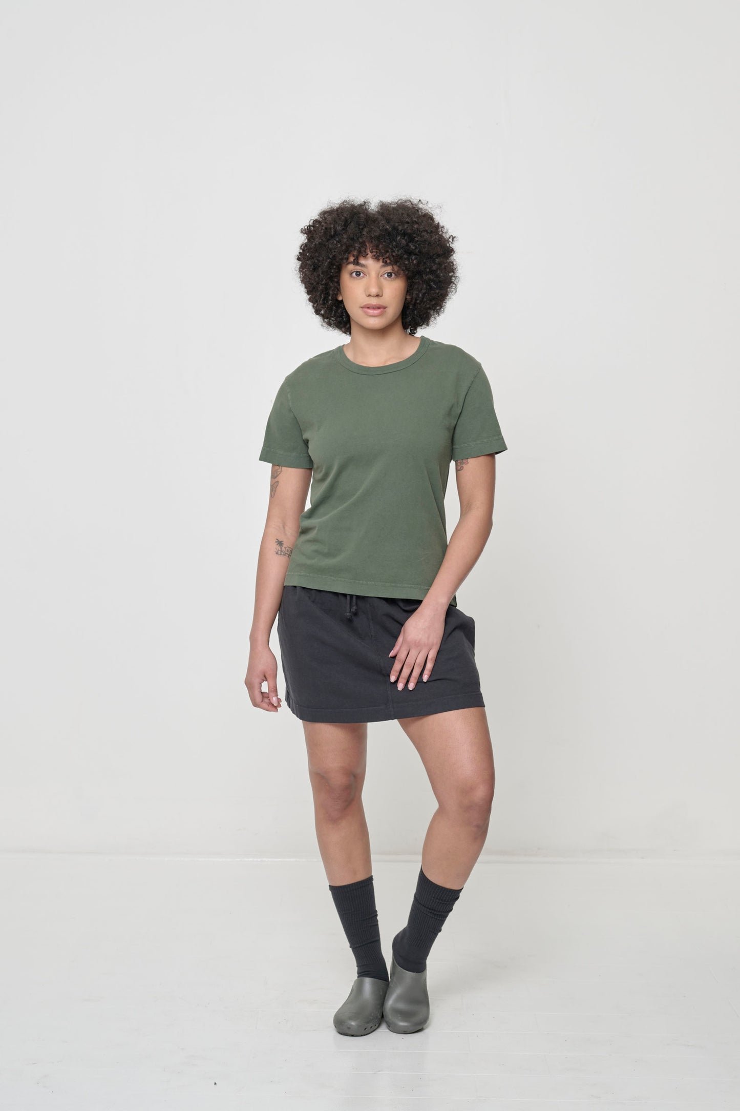 Styled with black short skirt, Black Squishy Socks, and Metallic gray Calzuro Classic Clogs.